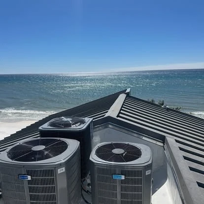 Affordable Air Service technician on a rooftop AC install overlooking the Gulf near Santa Rosa Beach